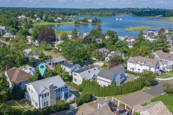 Aerial view of 14 Compo Hill Avenue with neighborhood, beach and water in the background